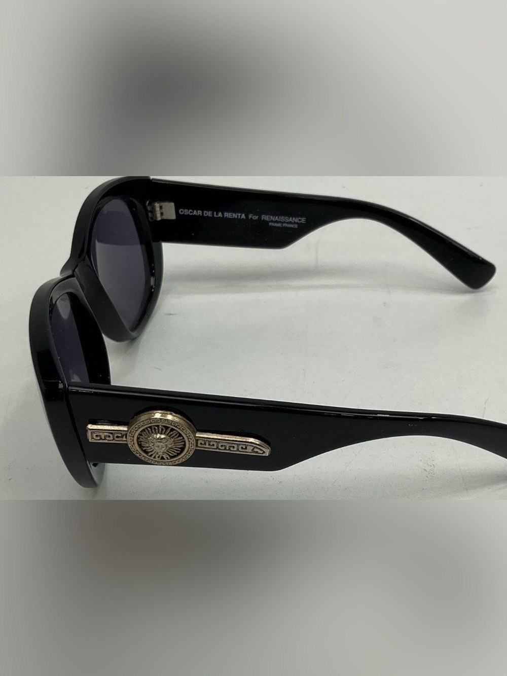 Oscar de la Renta Black Frames with Gold Medallion Accent